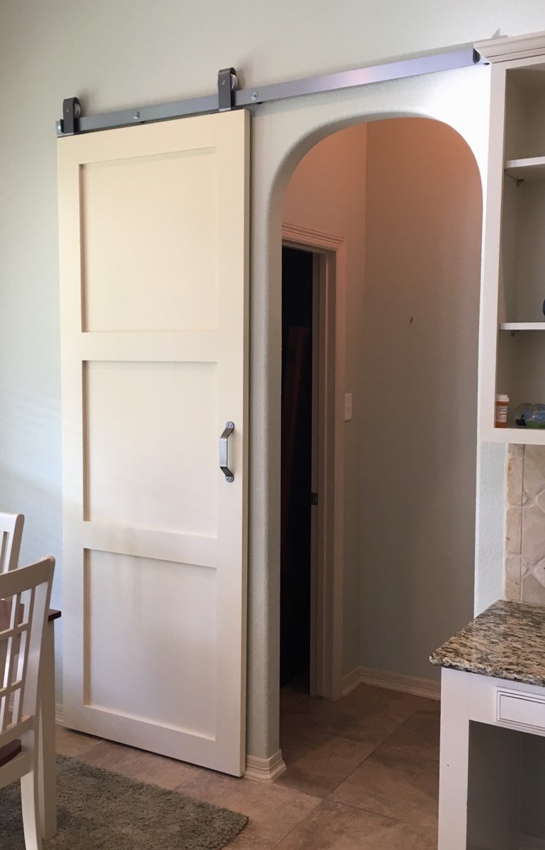 Contemporary style barn door in Southern California kitchen.